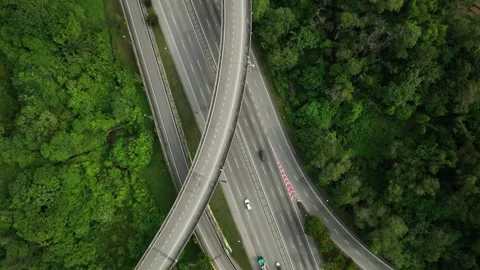 Highway interchange surrounded by lush greenery in a serene landscape Stock Footage 311987235