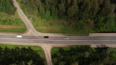 Highway with intersection and traffic. Around the forest. Aerial view Stock Footage 206283238