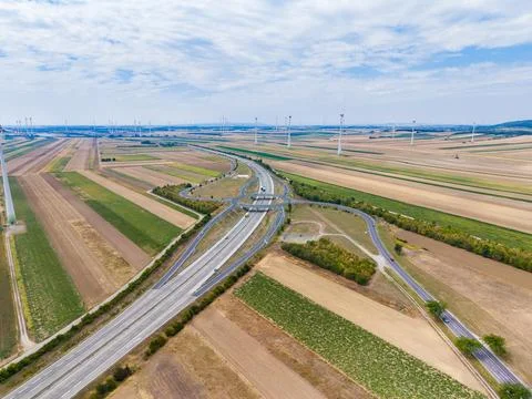 Highway intersection connects multiple roads in an open area with fields and  Stock Photos