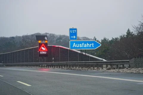 Highway message board warns of traffic jam with exit guidance. Stock Photos