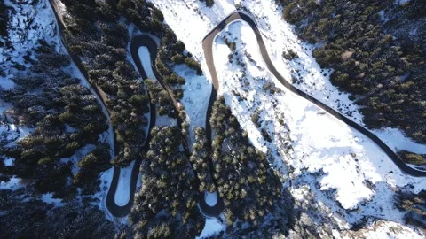 A highway in the mountains. Road in the snow from a height. Serpentine. Stock Footage 295133030