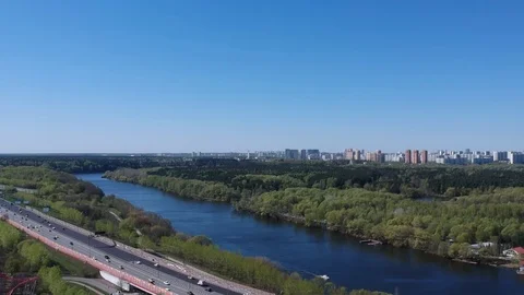 Highway overpass bridge on the background of the summer river and city park Stock Footage 107096433