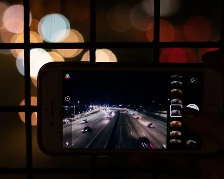 Highway overpass through the screen of a mobile phone. Stock Photos