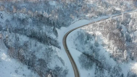 The highway passes through the pass in winter, top view of the snowy forest. Stock Footage 169581376