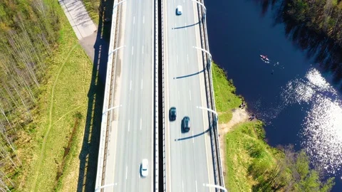 Highway passing through the rural countryside and green forest with moving cars Stock Footage 108721653