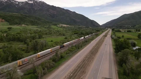 Highway road and freight train in mountains Stock Footage 247232847