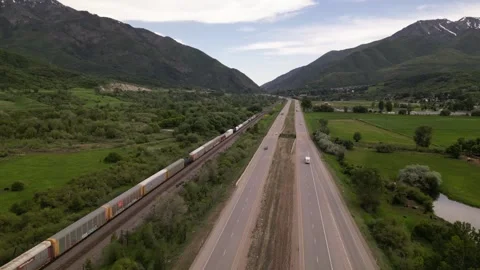 Highway road and freight train in mountains Stock Footage 247232854