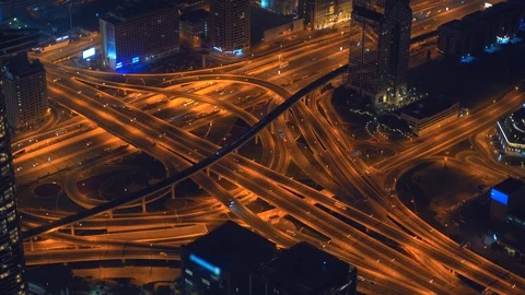 Highway road interchange or junction with urban car traffic at night in Dubai Stock Footage 125555028
