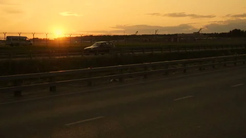 Highway road at sunset time. Slow motion footage of cars. Beautiful sundown Stock Footage 125627988