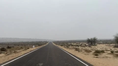 Highway road with tree view on the sides from  longewala to Jaisalmer Stock Footage 282792950