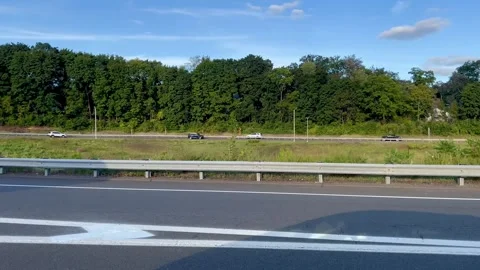 Highway Roadside View with Traffic Passing by Trees on Sunny Day Stock Footage 346261399