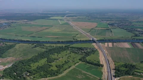 Highway running along river through open fields Stockbeeldmateriaal 321773327