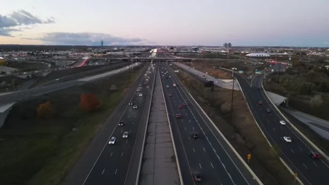Highway Serenity: Drone Captures Smooth Traffic and Urban Clouds Stock Footage 289563185