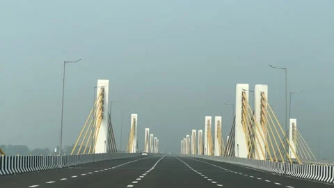 Highway showing the impressive engineering of a cable-stayed bridge with Stock Footage 325373883