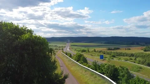 Highway in summer, sky with clouds, Germany, highspeed valley Stock Footage