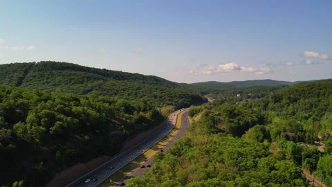 Highway Surrounded by Mountains in 4K Stock Footage 244475602