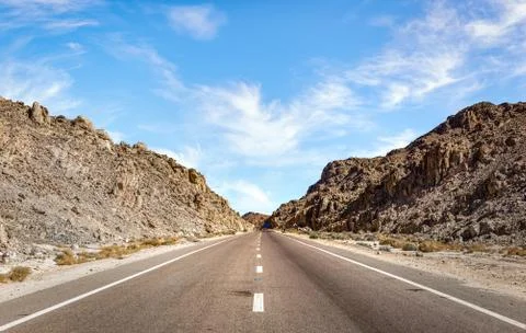 Highway through mountains Stock Photos