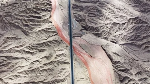 A highway through the mountains in the shadow of clouds. Stock Footage 282086323