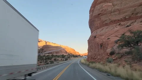 Highway through red rock mountains at sunset, Utah, USA Stock Footage 318565436