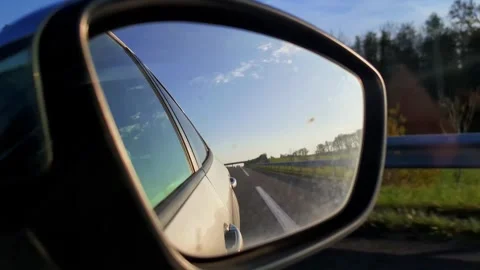 Highway through the side mirror of a car. Road marking line. Slow motion 4K. Stock Footage 292371579