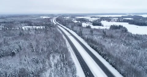Highway through snow forest at winter frozen day. Stock Footage 147040437