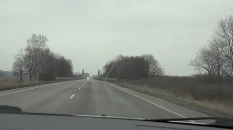 Highway through windshield of car, early spring Vídeos de archivo 47715009