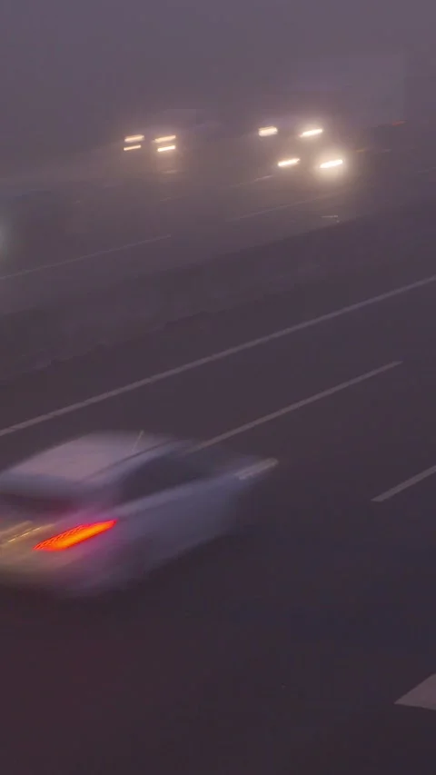 Highway traffic in mist -  white headlights and red tail lights Stock Footage 311575441