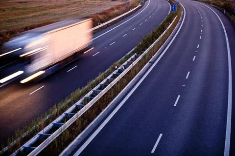 Highway traffic - motion blurred truck on a highway/motorway/spe Stock Photos