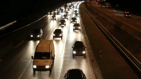 Highway traffic moving very fast at night Stock Footage 67676502