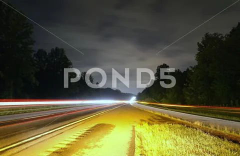 Highway traffic at night Stock Photos
