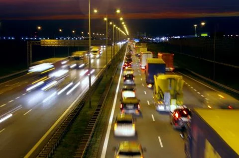 Highway traffic by night Stock Photos