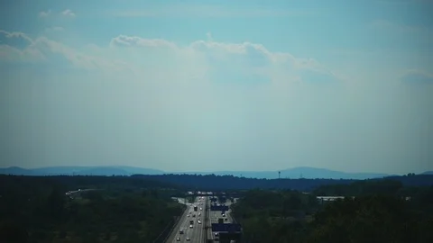 Highway Traffic in Real Time through Forest Stock Footage 90787917