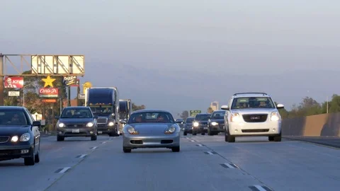 Highway traffic at sunset Stock Footage 73897780