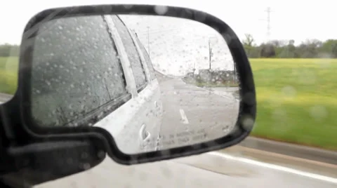 Highway travel seen through a side view mirror raining Stock Footage 37348708