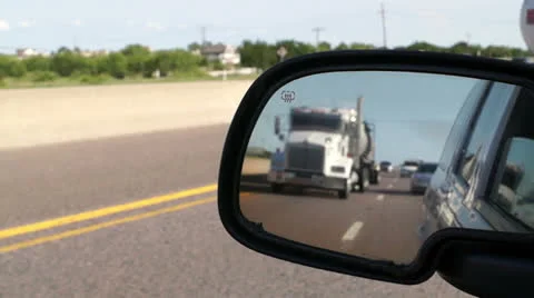 Highway travel through a side view mirror Stock Footage 25913627
