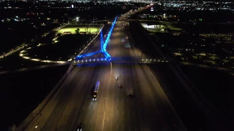 Highway with two overpasses and public art at night Stock Footage 240222020