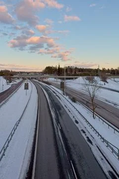 Highway in winter with clouds in the sky. Stock Photos