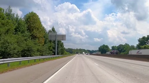 Highwayscapes rear view of traffic and blue sky with clouds Stock Footage 144227380