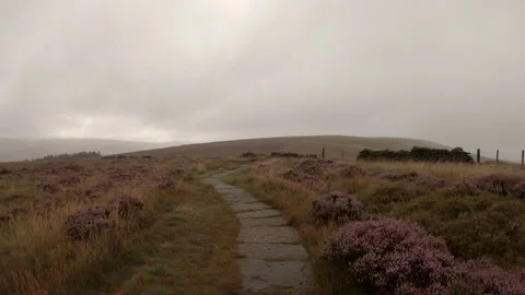 Hike along stone path by wall in bad weather Stock Footage 161755946