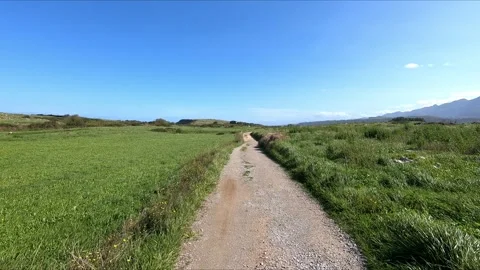 Hike a footpath between green meadows Stock Footage 275250708
