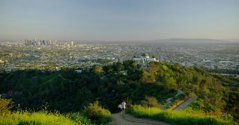 Hike trail and the Griffith Observatory and downtown LA skyline in the distance Stock Footage 81551558