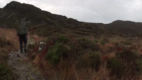 A hike walking through thick brown red mountain foreground Vídeo Stock 172140927