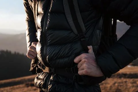 Hiker adjusting backpack straps during hike Stock Photos