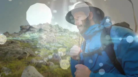 Hiker adjusting jacket on hillside, showing animated heart icon and elevation Stock Footage 308185578