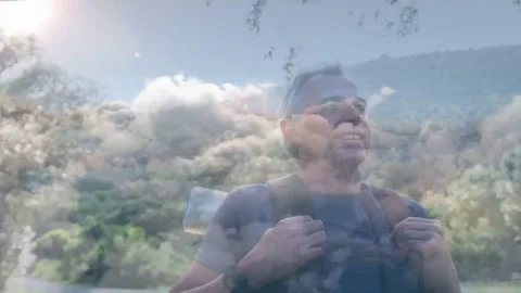 Hiker adjusting straps while sun flare drawing gaze taking travel view as cloud Stock Footage 332380772