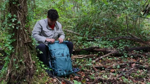 Hiker advises on preparedness while retrieving a first aid kit from his bac.. Stock Footage 289007751