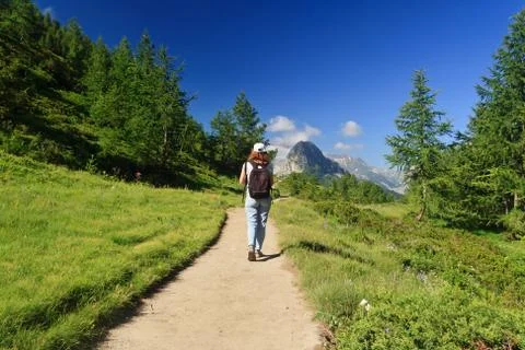 Hiker in alpine path Stock Photos