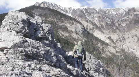 Hiker ascending to the mount top Stock Footage 13837415