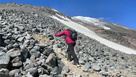 Hiker ascending in side view over rocky Mount Ararat terrain Stock Footage 343804919