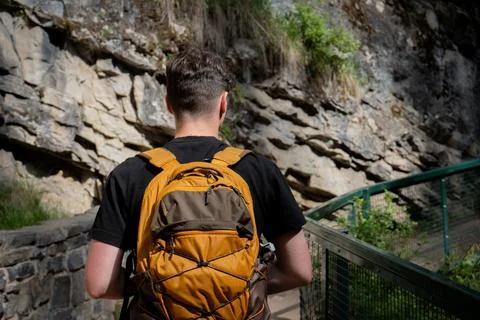 Hiker with a backpack exploring a rocky trail Stock Photos